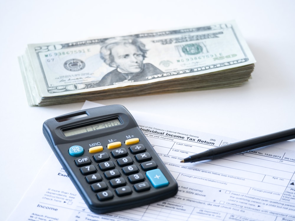 Money with calculator over form