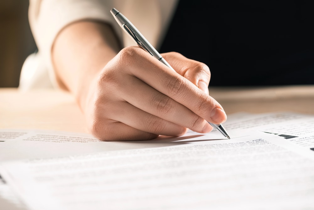 business woman signing paperwork